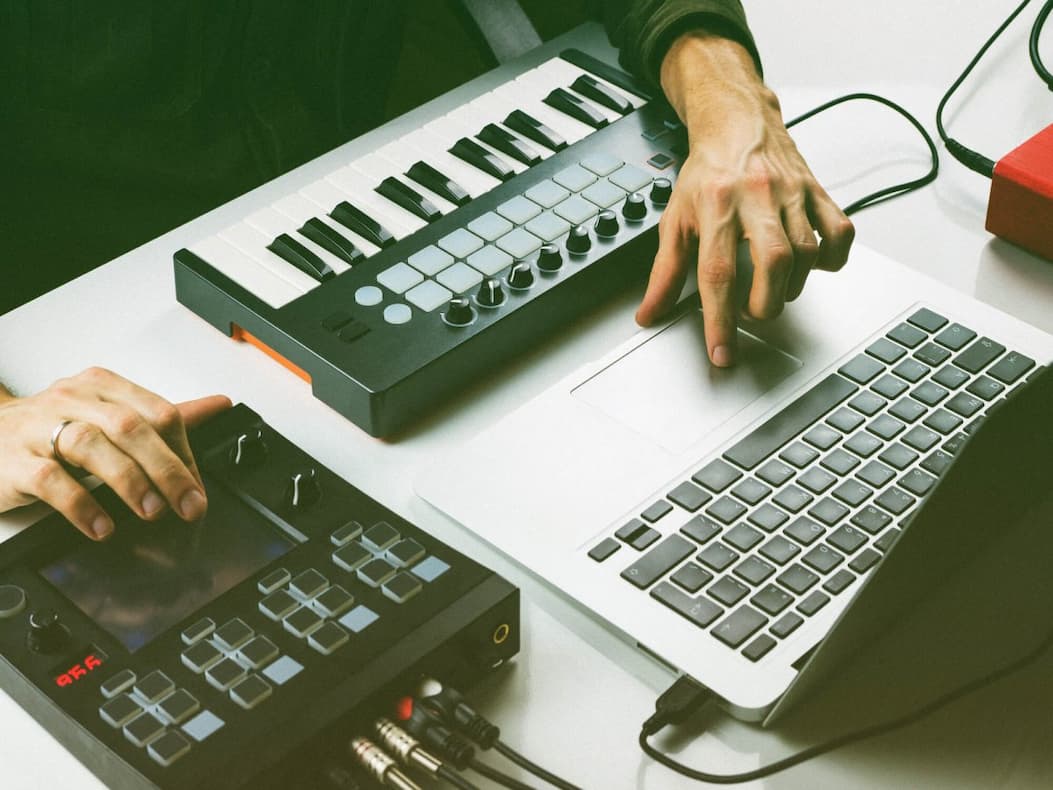 Composer working with a MIDI keyboard and pad controller